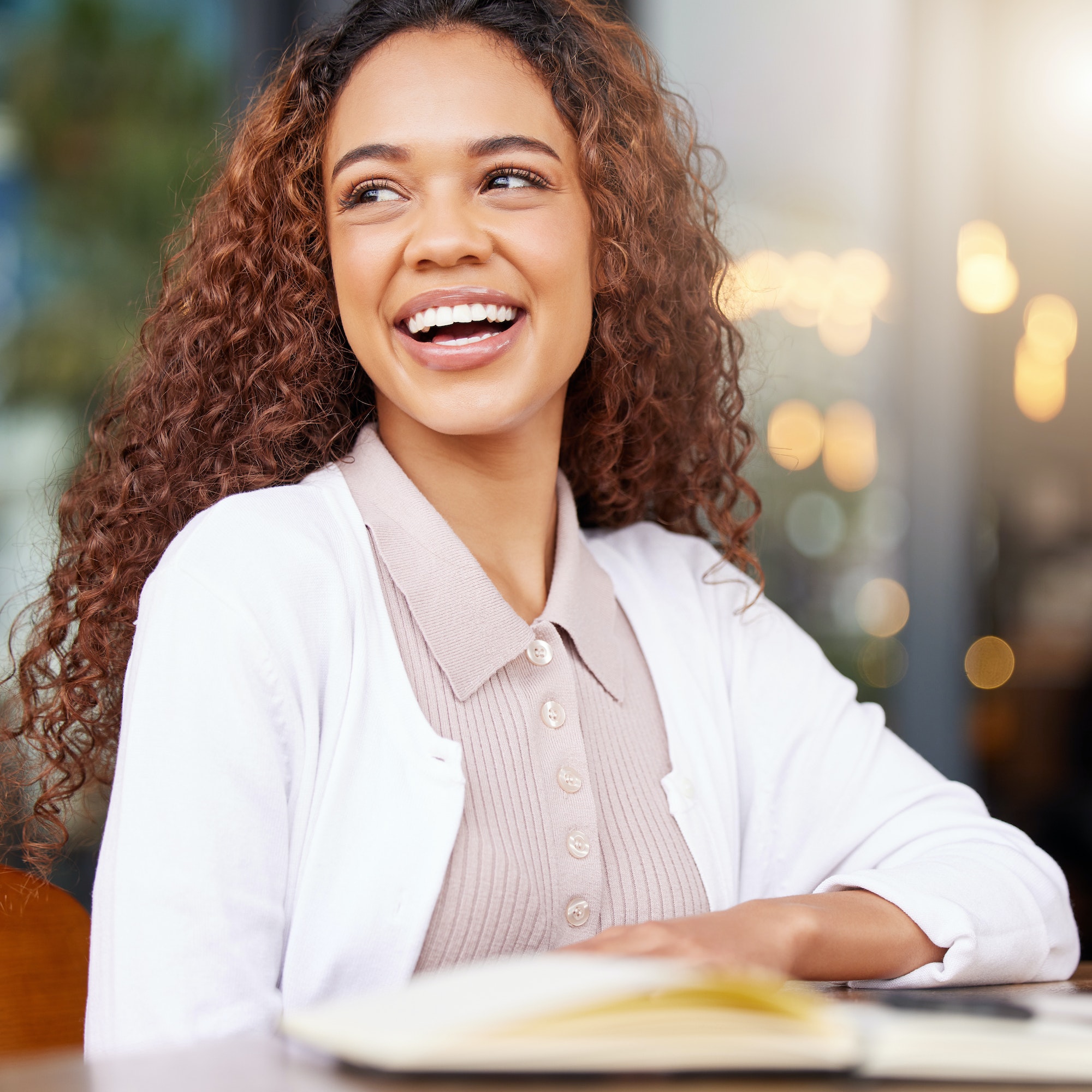 Smiling at my bright future. Shot of a young businesswoman working at a cafe.